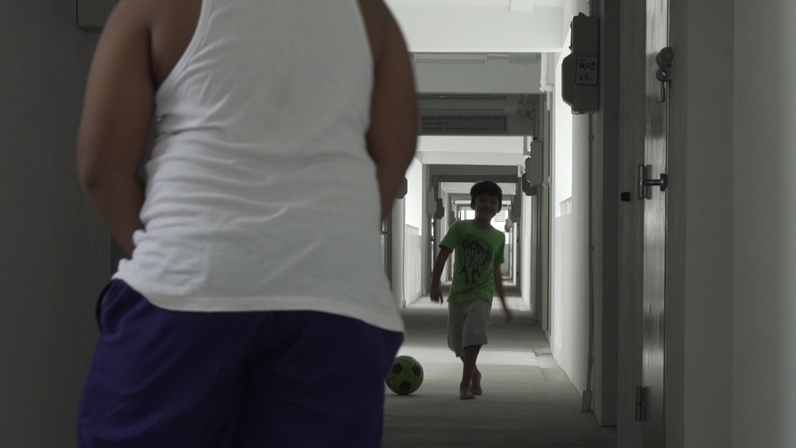 Fizah's children playing football in the corridor